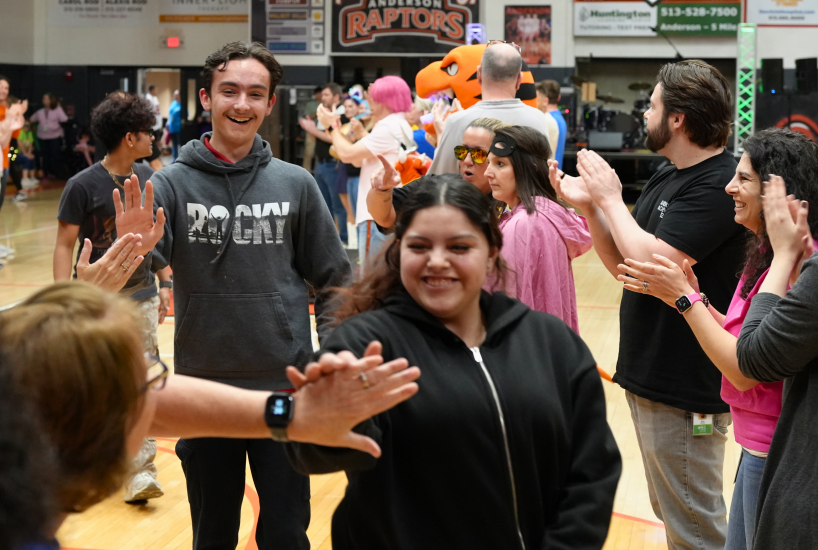 students high five teachers at the academic pep rally